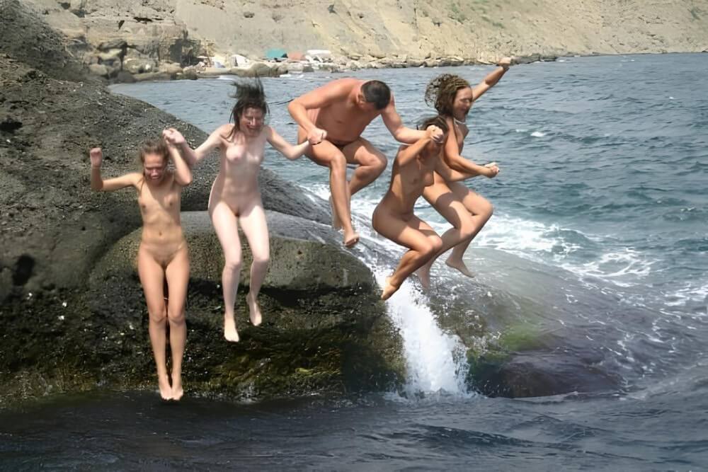 Mens and girls nudists on a beach - The worship of the naked body