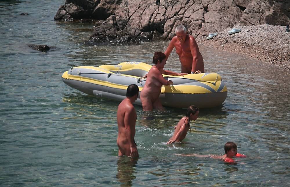 Lone Nudist in Yellow Boat photos - Nudism and naturism promote inner happiness and harmony