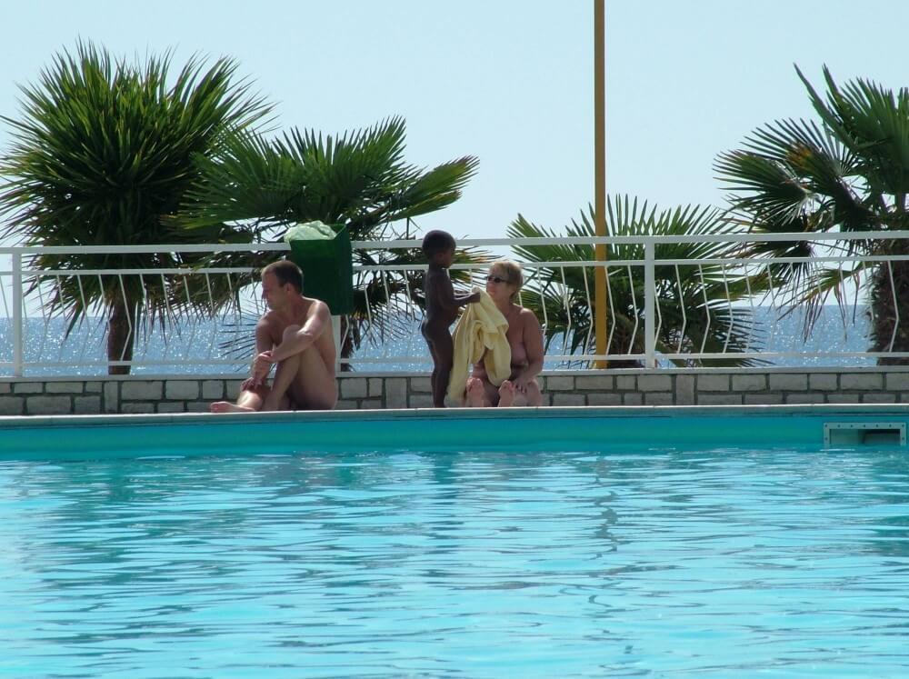 Photo of naturists in an outdoor pool - Nudism strengthens friendships and mutual respect among people